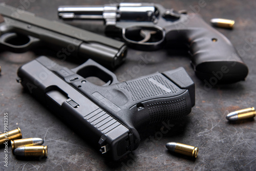 Gun with ammunition on dark background. 