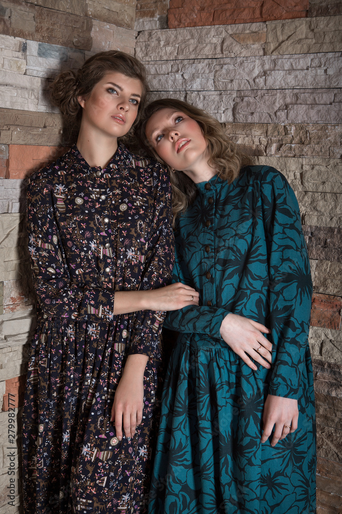 advertising of fashion for woman: dress, shoes. two happy girls smiling. Portrait of women hugging. The concept of relationships in the family, friends, sisters, couple in love. advertising of fashion for woman: dress, shoes. two happy girls smiling. Portrait of women hugging. The concept of relationships in the family, friends, sisters, couple in love.