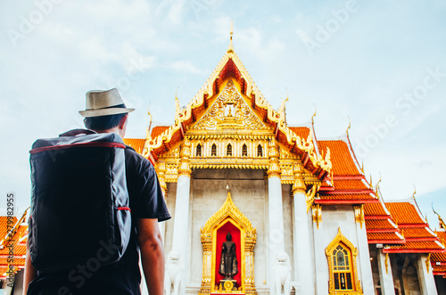 Asia tourist, Asian man traveling backpacker at Wat Benchamabophit Dusitvanaram in Bangkok, Thailand . photo