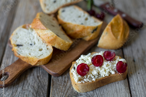 sliced sourdough toast with creamy yogurt and fresh cherries. Vintage wooden table, rustic style