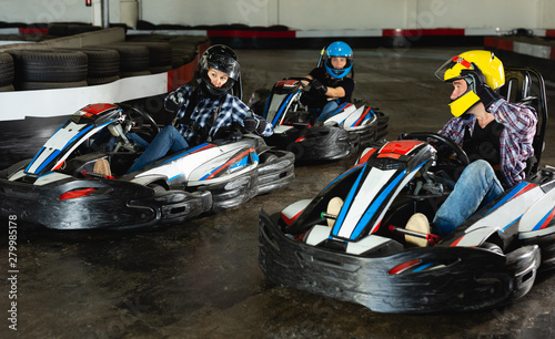 People driving go-kart cars