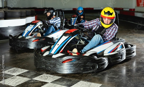 Group of people driving go-carts at racing track
