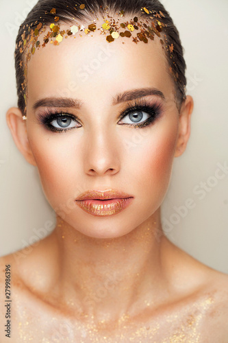 Woman with gold makeup