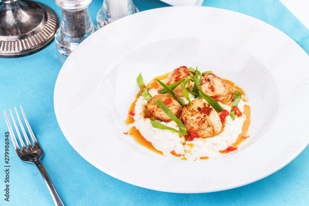 Mediterranean fish on a mashed potato pillow with tomato sauce Mediterranean fish on a mashed potato pillow with tomato sauce