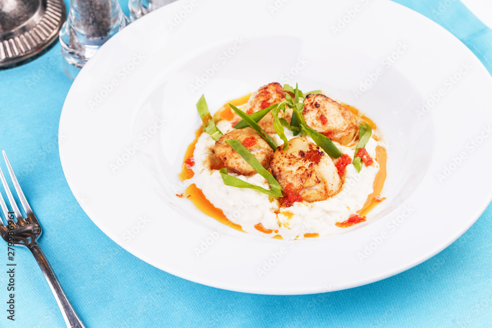 Mediterranean fish on a mashed potato pillow with tomato sauce Mediterranean fish on a mashed potato pillow with tomato sauce