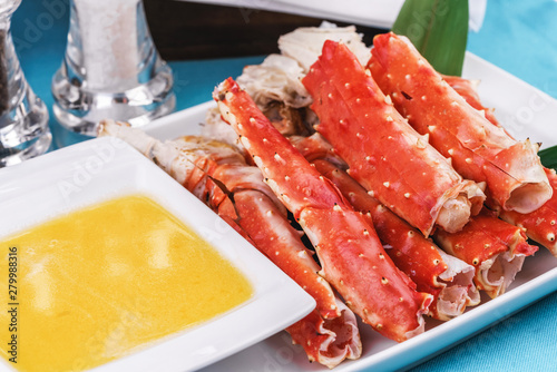  European recipe, Mediterranean dish. Boiled crab legs served with oil sauce and bamboo leaves