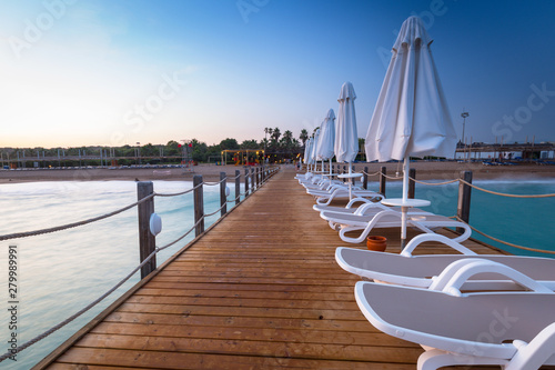 Fototapeta Naklejka Na Ścianę i Meble -  Beautiful scenery with wooden pier on Turkish Riviera at sunset, Side