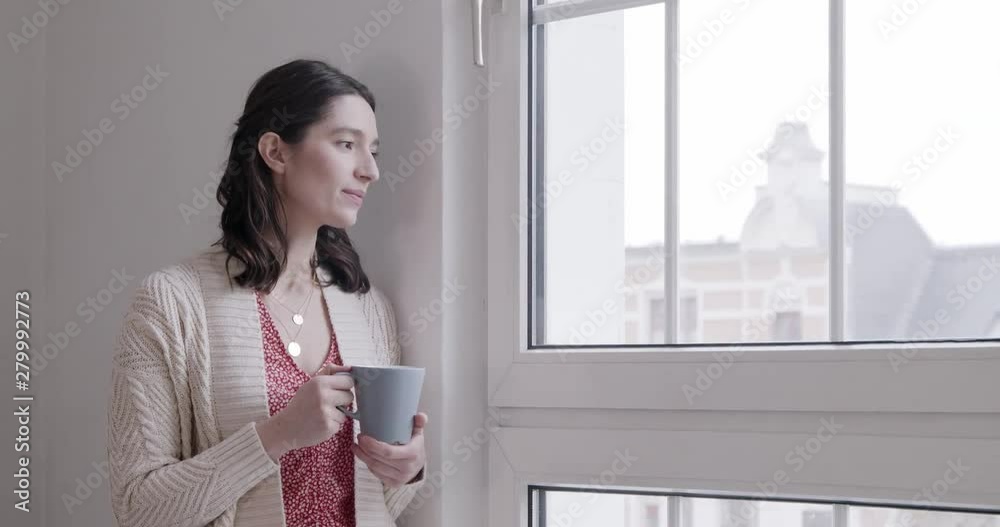 Young woman at home enjoying a cup of coffee Young woman at home enjoying a cup of coffee