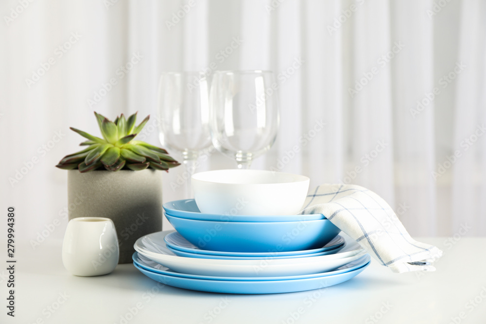 Cutlery with succulent plant stacked on white table, space for text