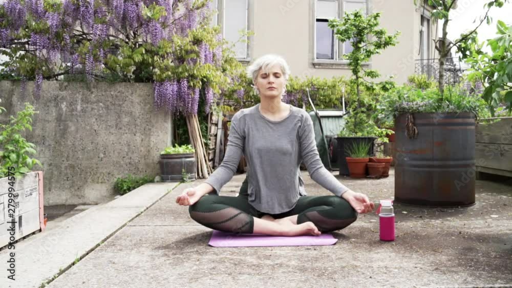 Woman doing Yoga on a rooftop Woman doing Yoga on a rooftop