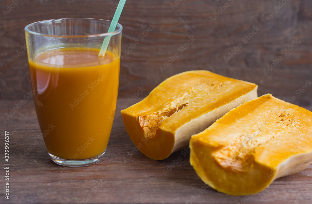 fresh pumpkin juice and pumpkin on wooden background,delicious autumn drink fresh pumpkin juice and pumpkin on wooden background,delicious autumn drink