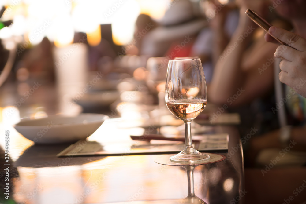 glasses of white wine on a table in restaurant, selective focus