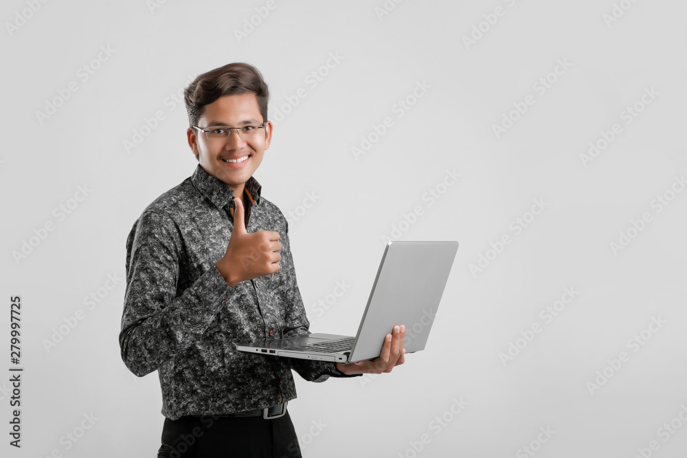 Young Indian / Asian man working on laptop Young Indian / Asian man working on laptop