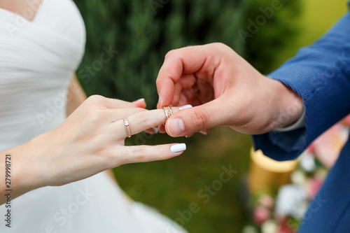 Newlyweds put each other rings on the ceremony © Parfenova