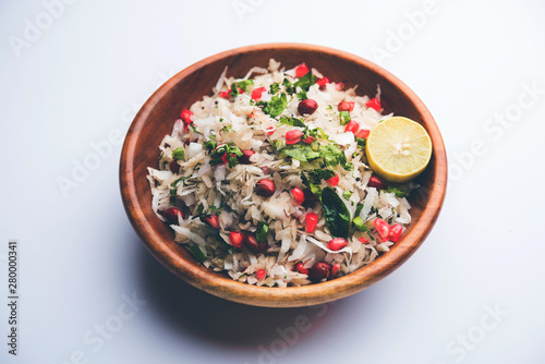 Dapde Pohe is a typical Maharashtrian breakfast, made with thin variety of poha and fresh coconut with chilli, peanuts and nuts. served in a bowl or plate. selective focus