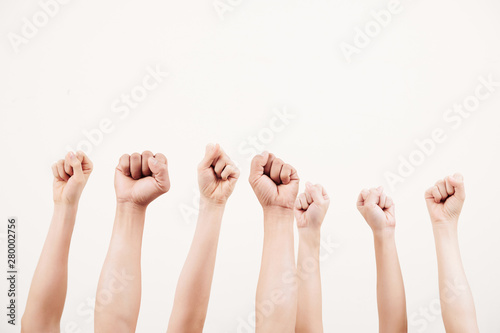 Close-up of business group raising their fists up and demonstrating power isolated on white background