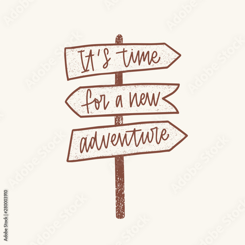 It's Time For A New Adventure inspirational phrase handwritten with elegant cursive font on signpost or guidepost