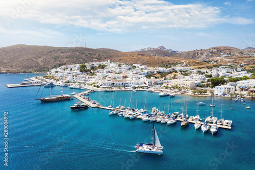 Aerial view to Adamas town, the port of Milos island, with blue sea and sailing boats and yachts in the marina, Cyclades, Greece photo