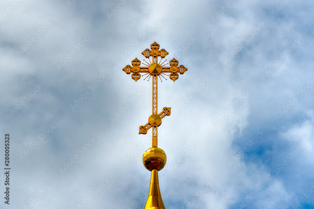 Orthodox Church, golden domes with crosses close-up against a blue cloudy sky, HDR photo. Orthodox Church, golden domes with crosses close-up against a blue cloudy sky, HDR photo.