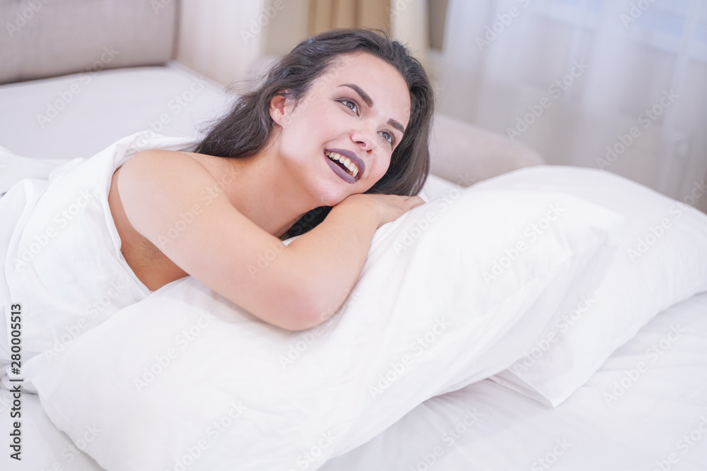 charming young brunette girl resting in her white bed charming young brunette girl resting in her white bed