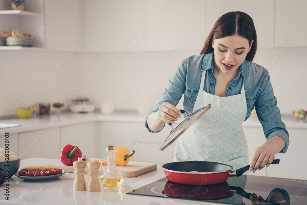 Photo of wife process making traditional family dish check if it ready wear dotted apron bright kitchen Photo of wife process making traditional family dish check if it ready wear dotted apron bright kitchen