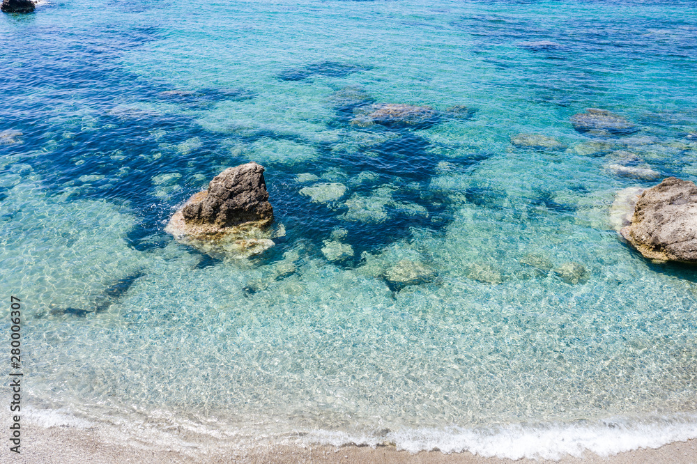 Aerial view of beautiful rocky coastline with turquoise sea water..