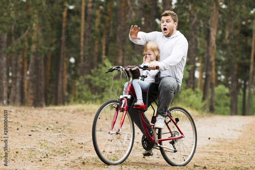 Worried father and daughter on bicycle