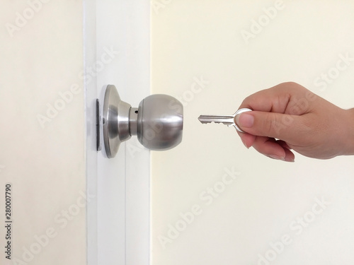 Open the whitedoor with the keys. Door knob with a key. photo