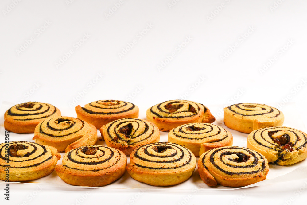 Baked cookies with raisins and poppy seeds isolated on white background.