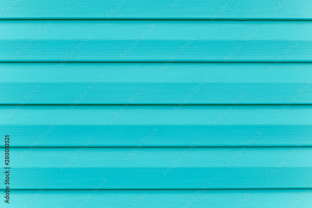 Fototapeta premium Turquoise fence. Plank - timber. Painted blue wooden table in lines. Striped panel, surface, background. Slats texture. Copy space. Abstract bright green pattern of logs.