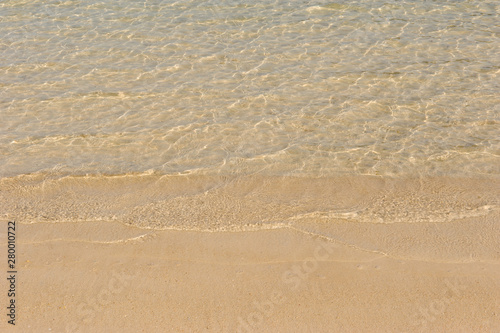 clear sea water surface and sandy beach