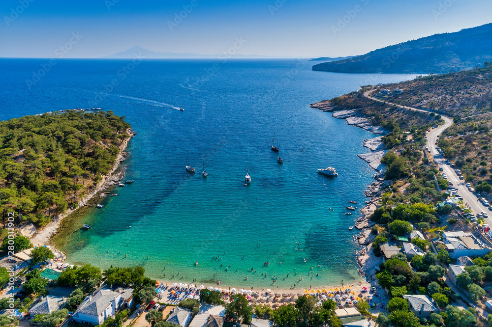 Aerial View of the Aliki Beach with colorful umbrellas, at Thassos island, Greece