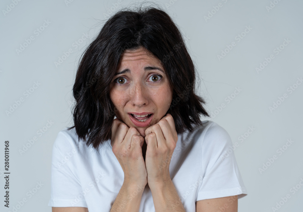 Portrait of a young attractive woman looking scared and shocked.Human expressions and emotions Portrait of a young attractive woman looking scared and shocked.Human expressions and emotions