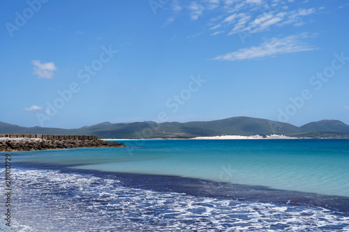 Beatiful beach in Sardinia with clear blue sky and turquoise blue water
