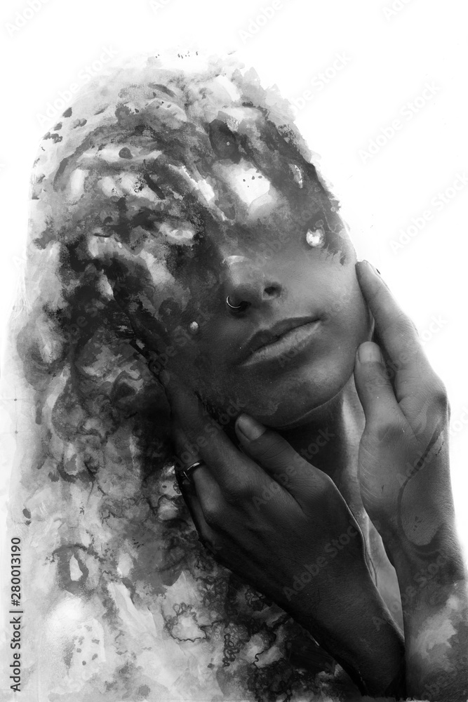 Paintography. Double exposure. Close up of an attractive model combined with hand drawn ink painting seemingly dissolving her forehead