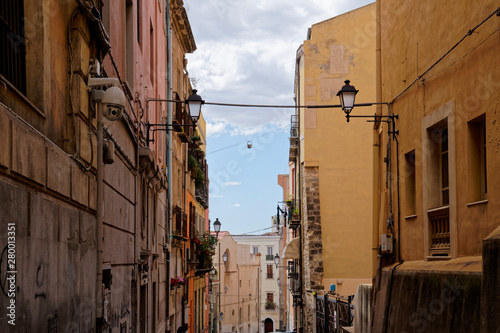 Typical row houses in Cagliari in Italy (Sardinia) with zipline and hanging basket between the windows.