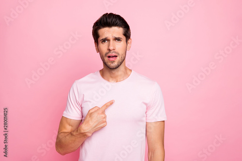 Portrait of his he nice attractive lovely confused guy pointing at him self wrong solution decision isolated over pink pastel background