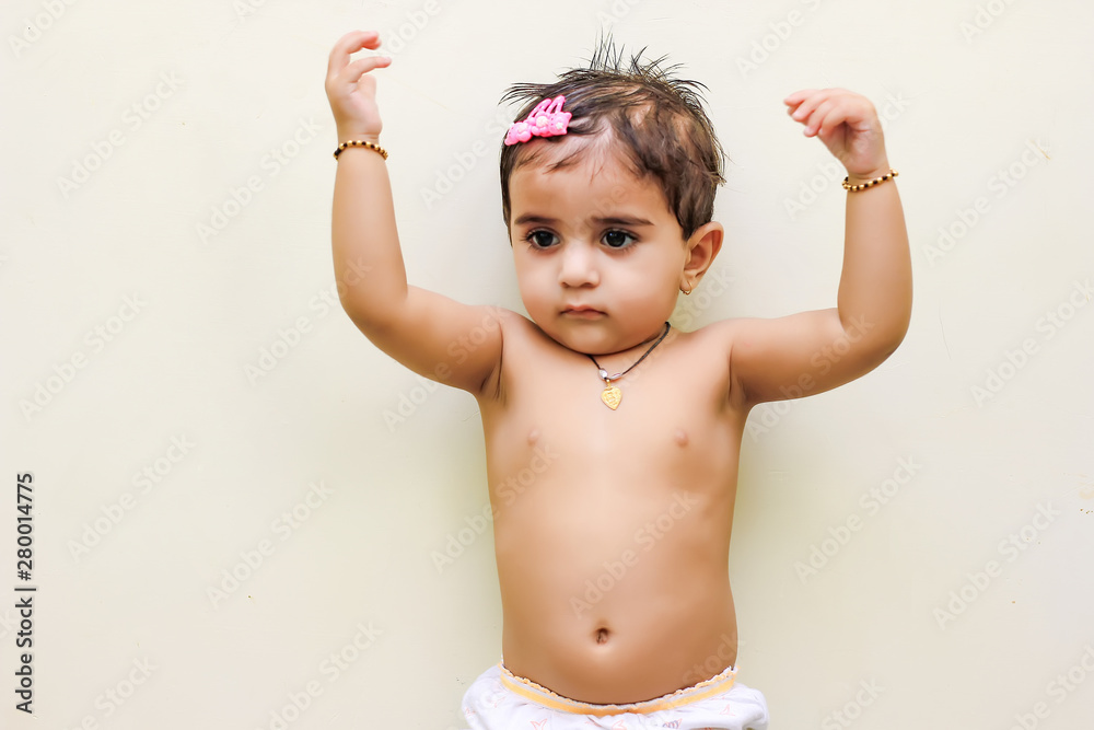 Obraz premium cute Indian baby girl playing at home
