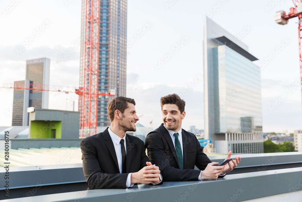 Two attractive young businessmen wearing suits Two attractive young businessmen wearing suits