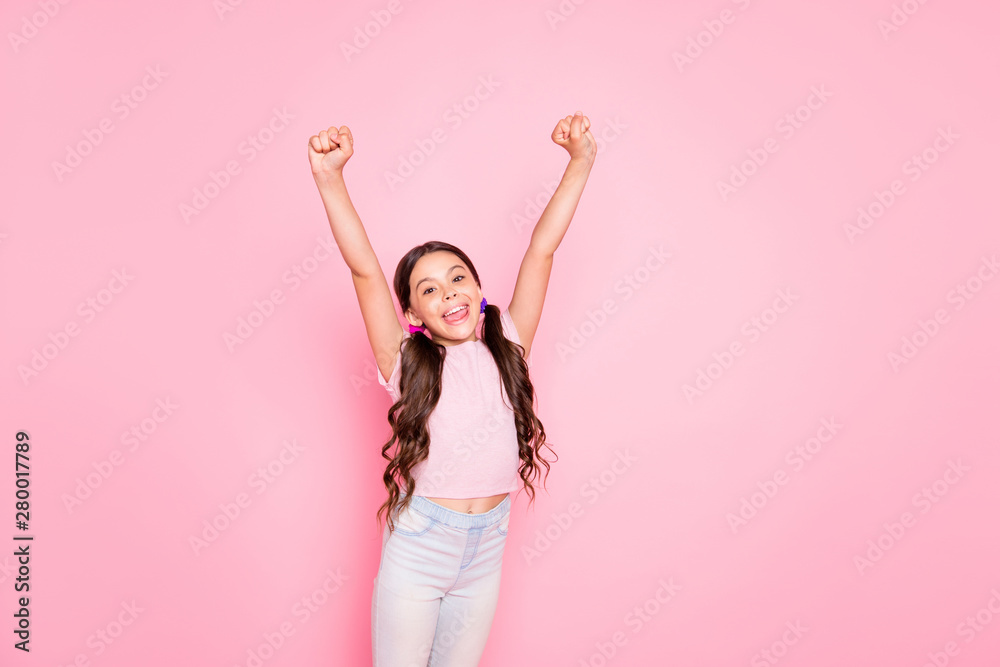 Portrait of cheerful child raising fists screaming yeah dressed white t-shirt pants trousers isolated over pink background Portrait of cheerful child raising fists screaming yeah dressed white t-shirt pants trousers isolated over pink background