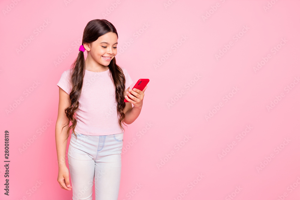 Portrait of lovely girl holding modern technology reading news dressed white t-shirt pants isolated over pink background Portrait of lovely girl holding modern technology reading news dressed white t-shirt pants isolated over pink background