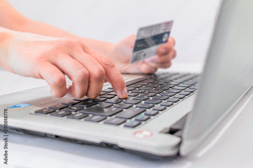 female hands typing on laptop keyboard