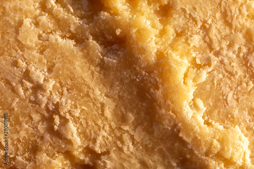 Italian Parmesan Cheese. cheese surface close-up. yellow abstract food background