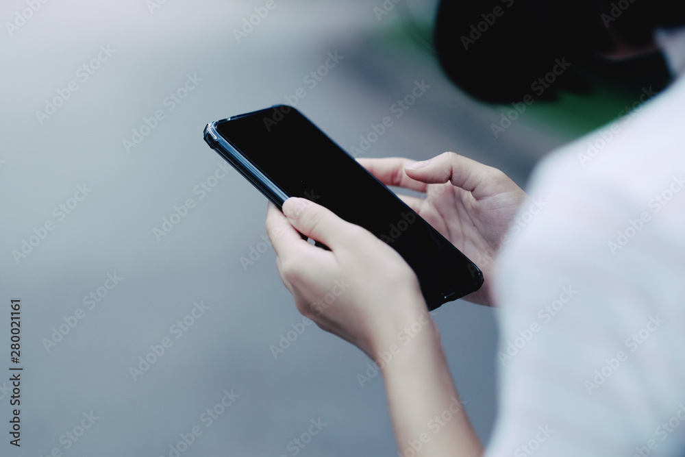 A girl using black smartphone for online shopping A girl using black smartphone for online shopping