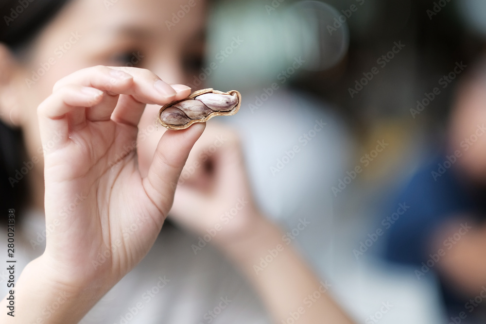 Asian woman eating peanuts Asian woman eating peanuts