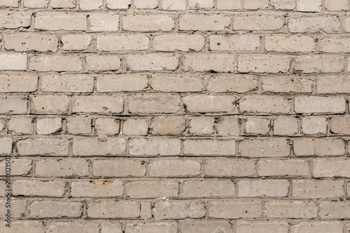 Beautiful horizontal texture of part of a old crashed brick gray wall is on the photo