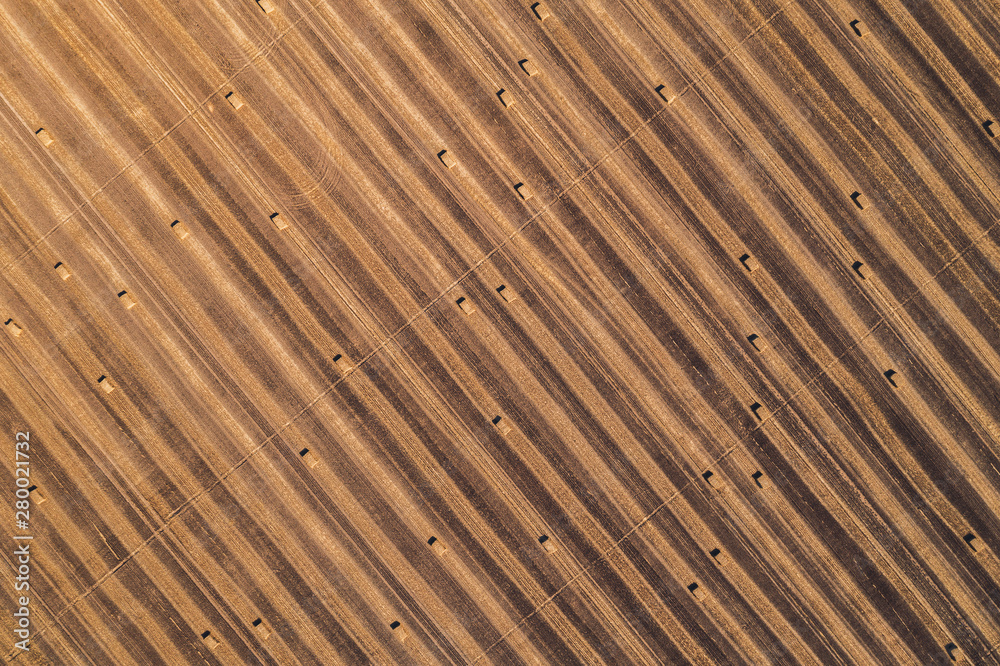 Aerial view of square hay bales in field after harvest Aerial view of square hay bales in field after harvest