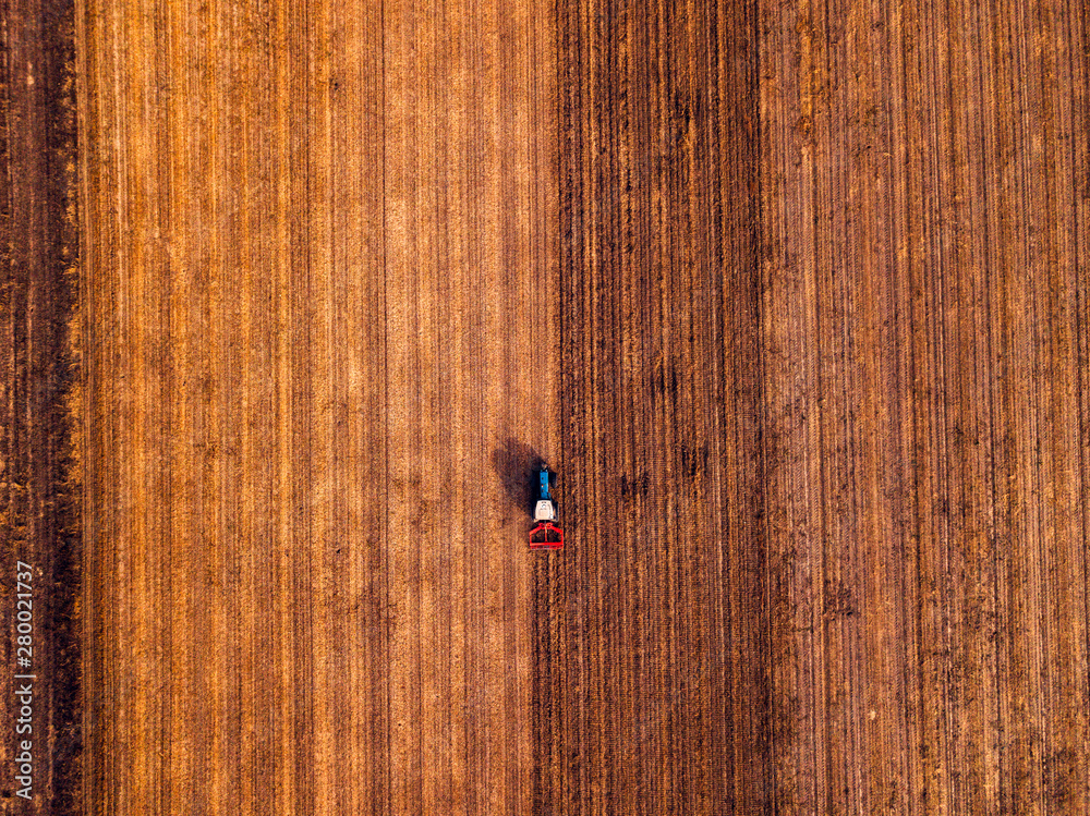 Aerial view of agricultural tractor doing stubble tillage Aerial view of agricultural tractor doing stubble tillage