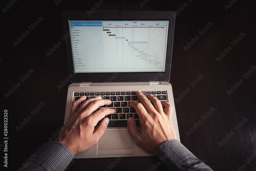 Close up of business man hands working on laptop computer in office. Business, digital technology, social network concept Close up of business man hands working on laptop computer in office. Business, digital technology, social network concept