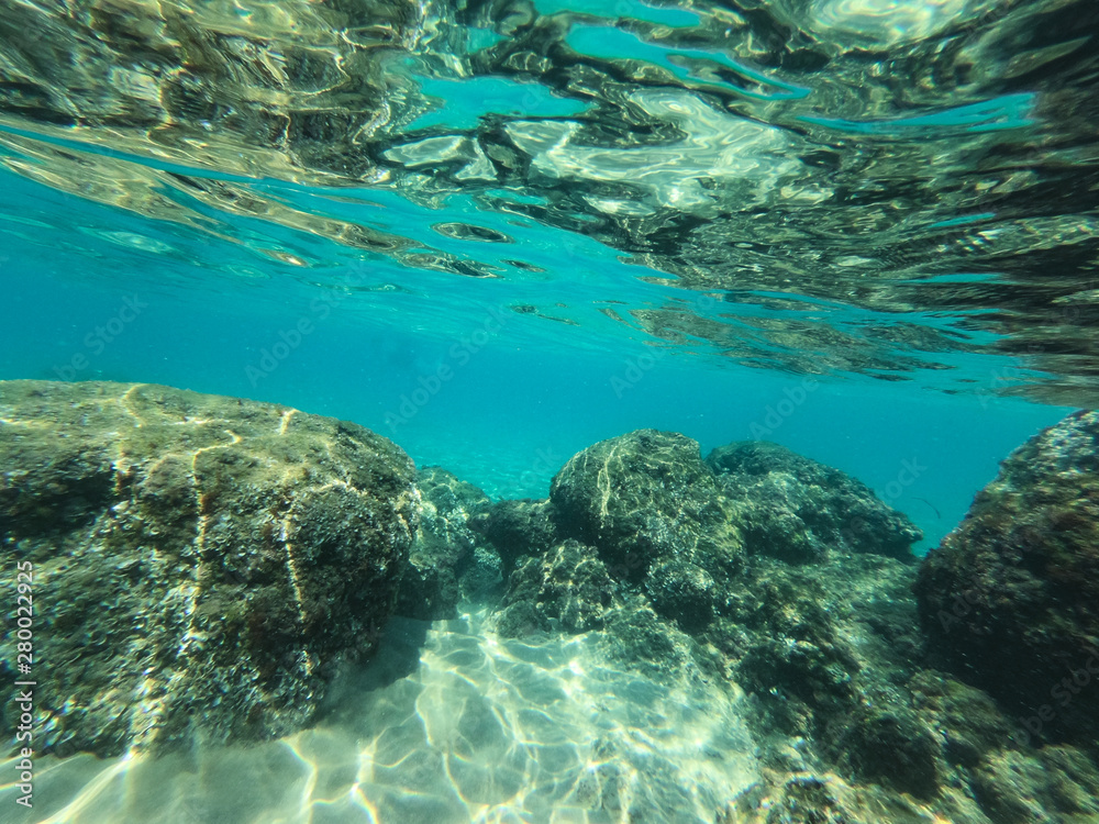 Underwater view of sea bottom with sand, rocks and stones.. Underwater view of sea bottom with sand, rocks and stones..